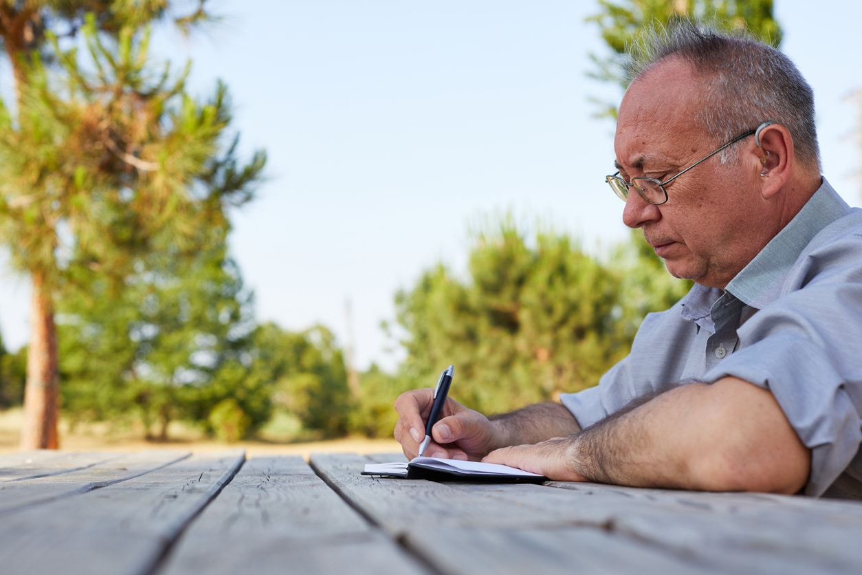 Man wearing hearing aid at the park.