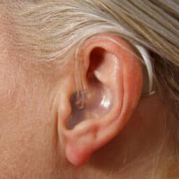 Close up shot of a clear, behind-the-ear hearing aid