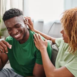 Happy couple, man wearing a new hearing aid