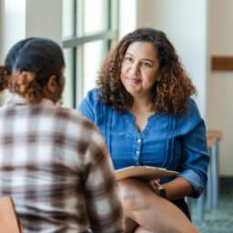 Young woman talking to her therapist.