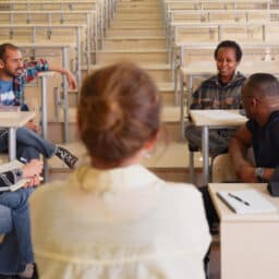 Group of college students sitting in a classroom having a discussion.